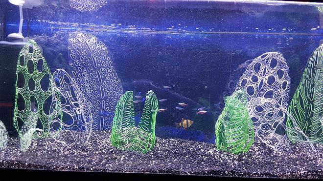 20 gallons freshwater fish tank (mostly fish and non-living decorations) - I'll probably get slaughtered for this but my attempts at growing plants have failed miserably. 
So, I decided to make my own ornaments from recycled drinks bottles (all certified food safe) shaped using a soldering iron. I'm really impressed with the results and the fish don't appear to mind. Would love feedback.